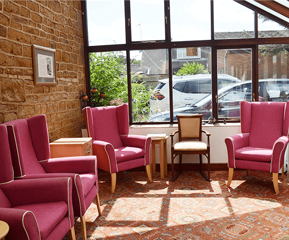 The conservatory lounge with armchairs at Fairholme House